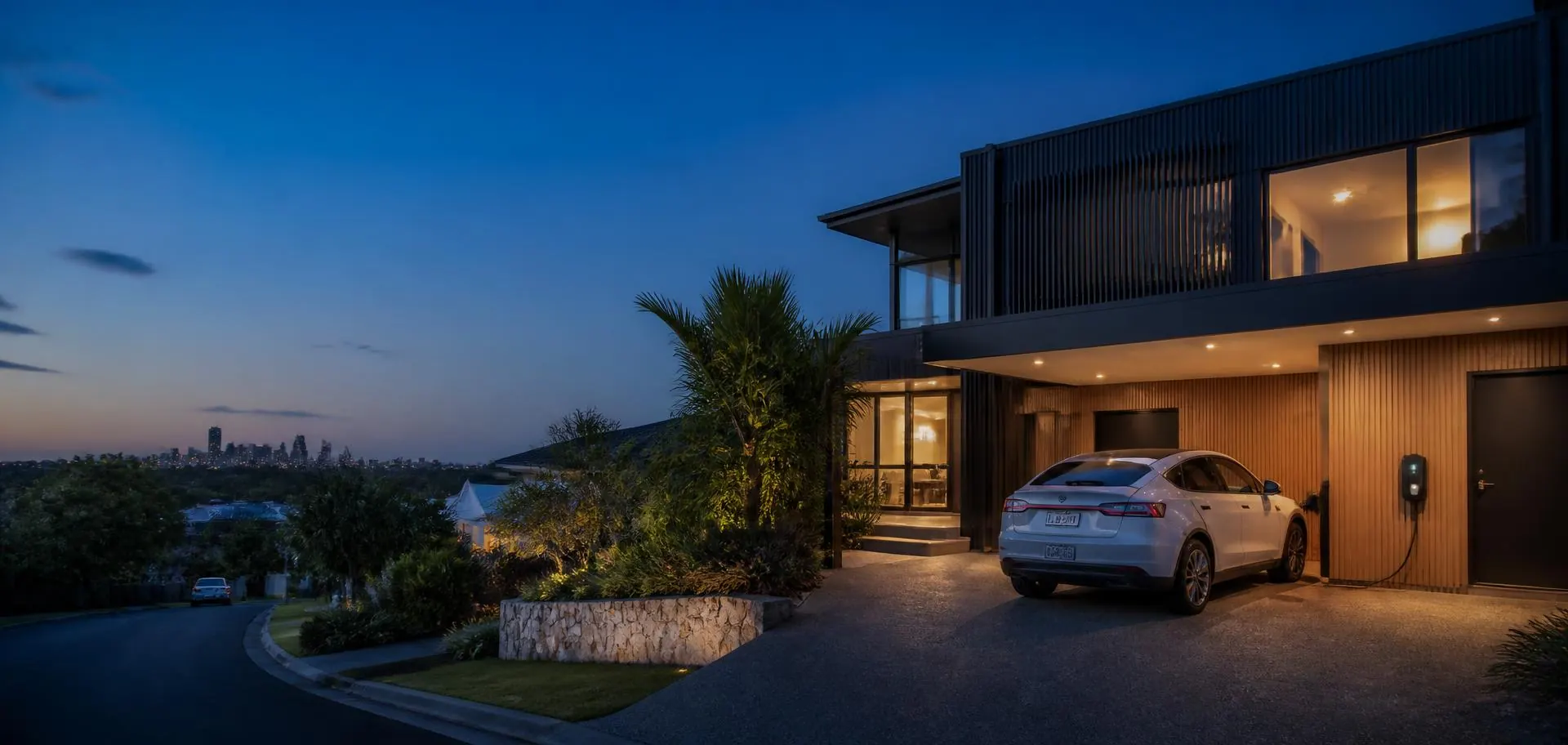 Electric car charging in the driveway of a contemporary Adelaide home at dusk